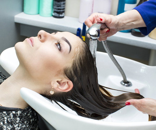 woman getting hair washed at a salon