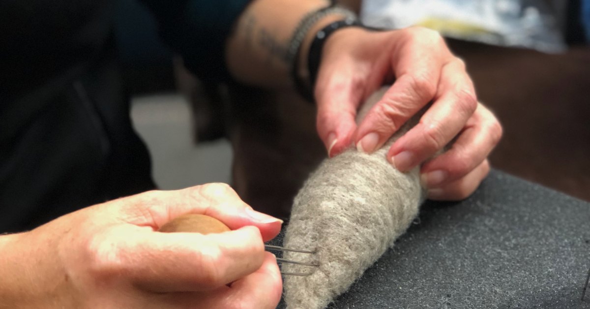 an artisan working with fiber
