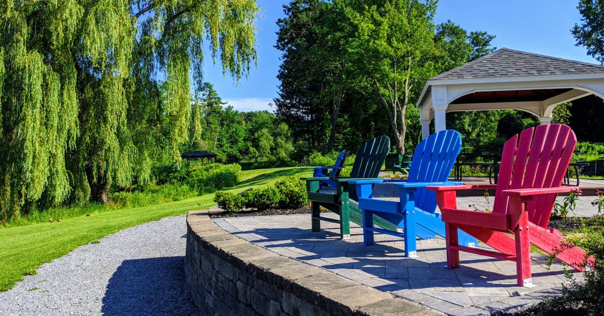 colored Adirondack chairs in park