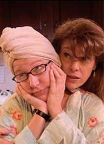 woman in glasses with hair wrapped in towel hugged from behind by another woman