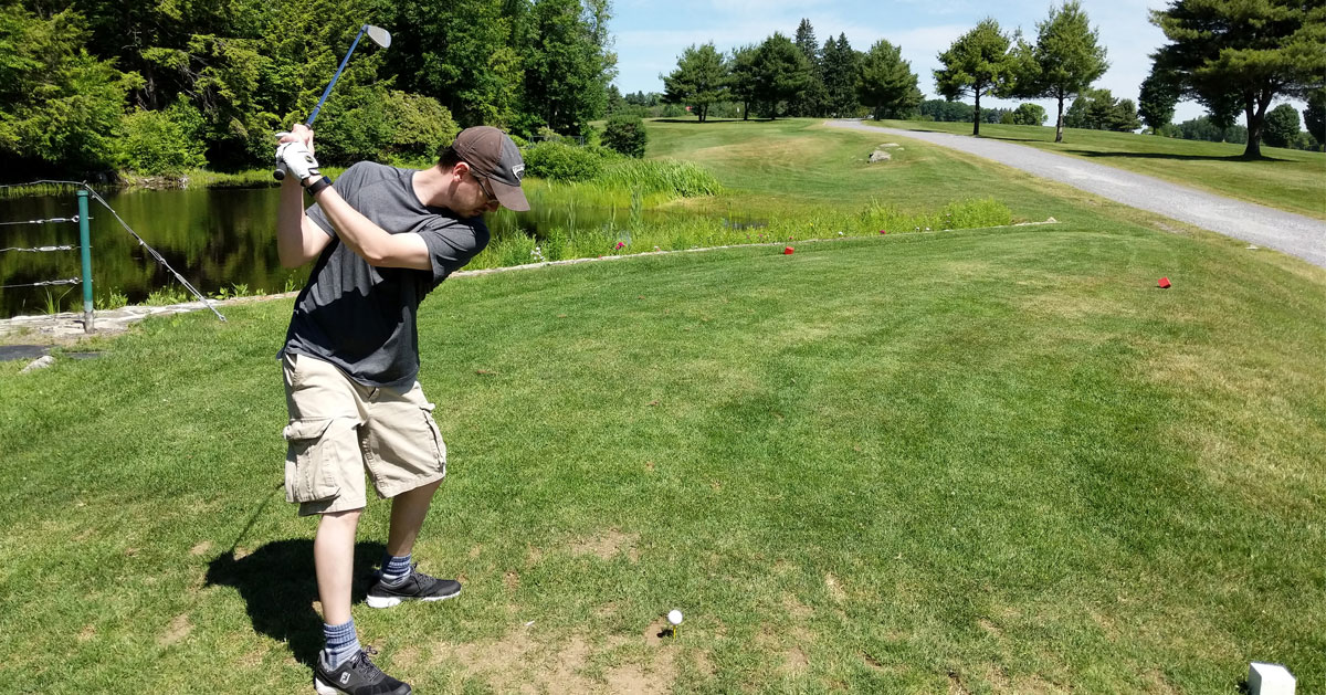 a man about to swing a golf club