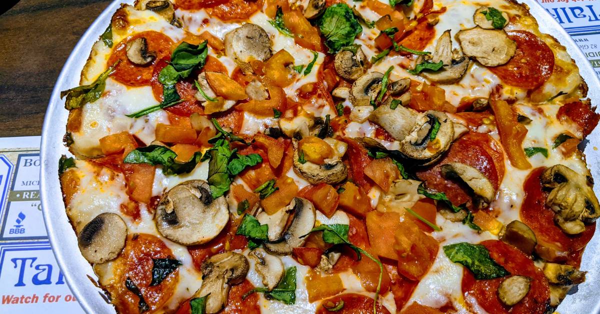 pizza with mushrooms, pepperoni, and spinach