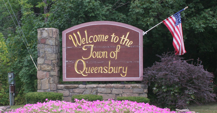sign that says "welcome to the town of queensbury"